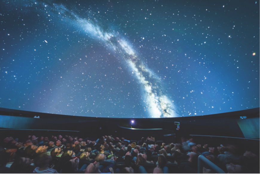 People looking at the night sky at a Planetarium 